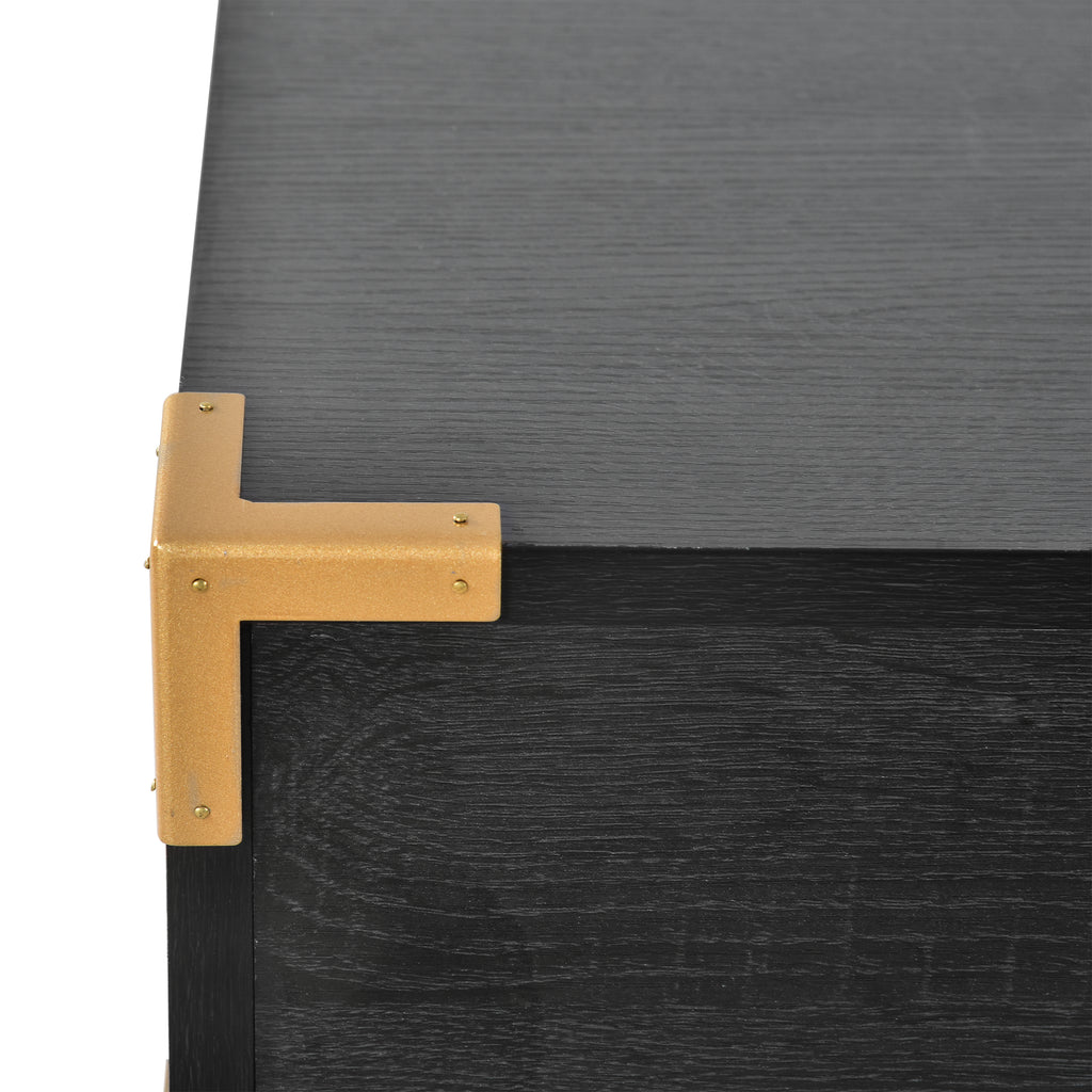 Black desk corner with gold metal L-bracket and sturdy leg support