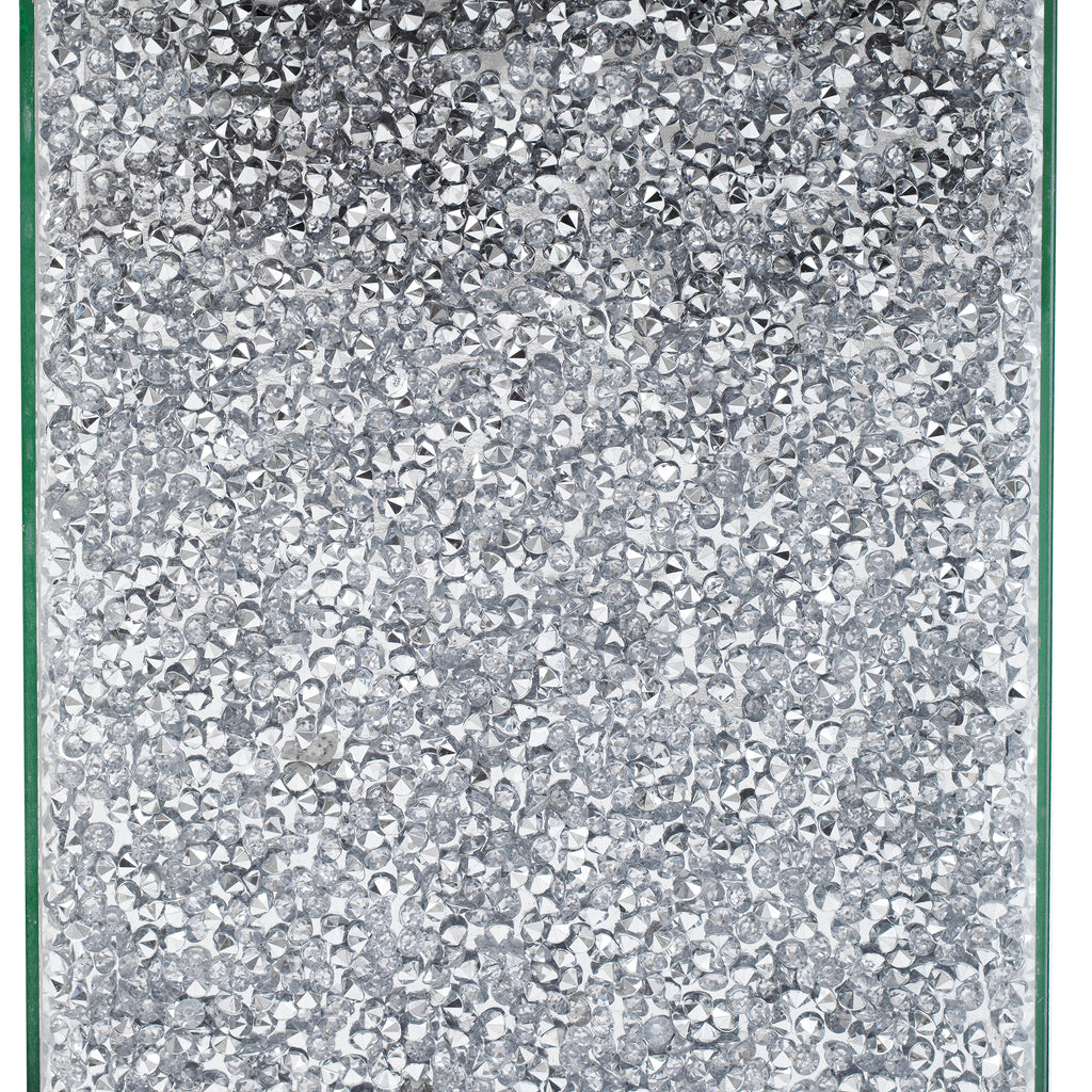 Close-up of silver glitter mirrored panels on a square mirror coffee table