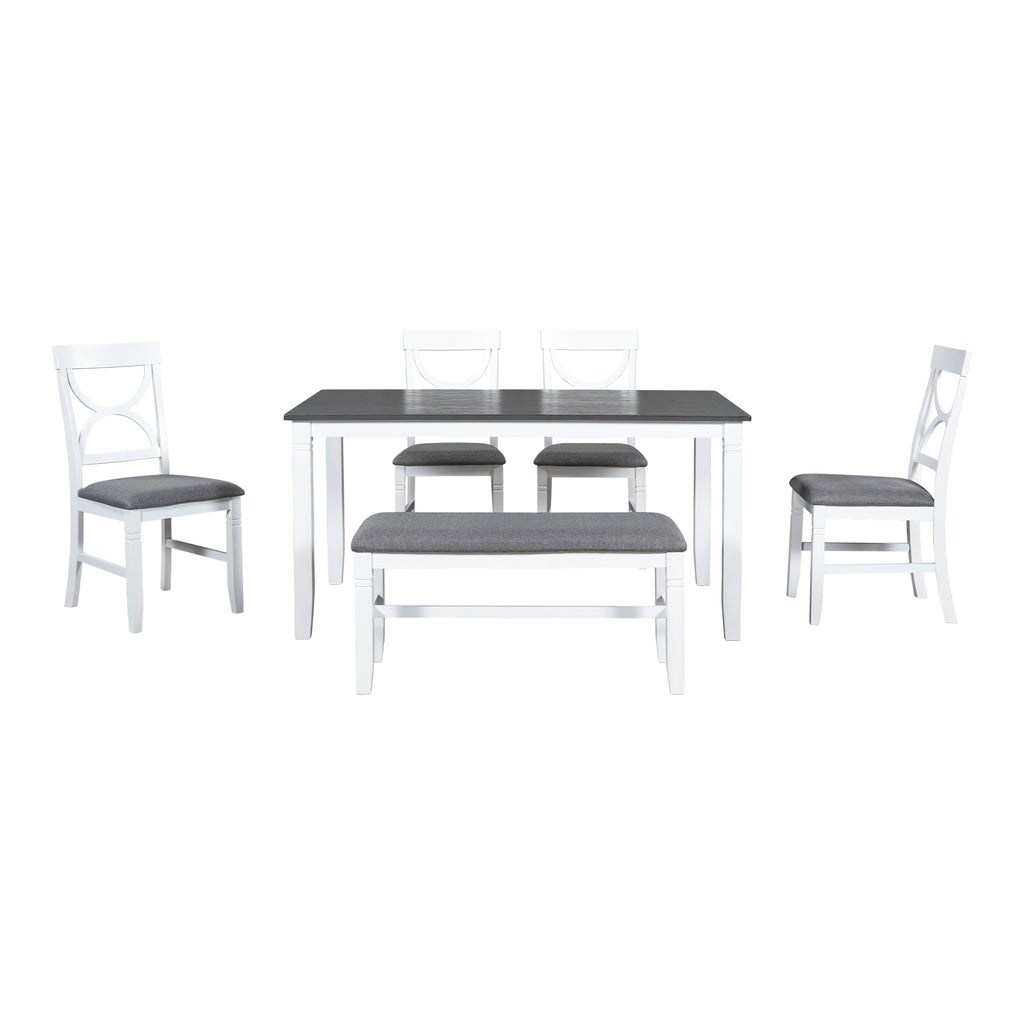 Dining table set with dark gray tabletop, gray bench, and white chairs