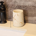Cream ceramic tumbler with golden marble veining, glossy finish, round rim