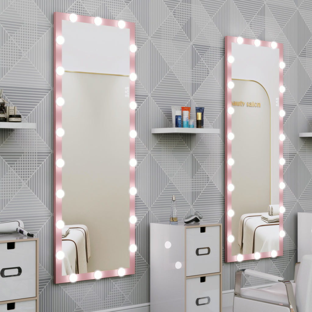 Pink lighted vanity mirrors with bulb borders in a bright room