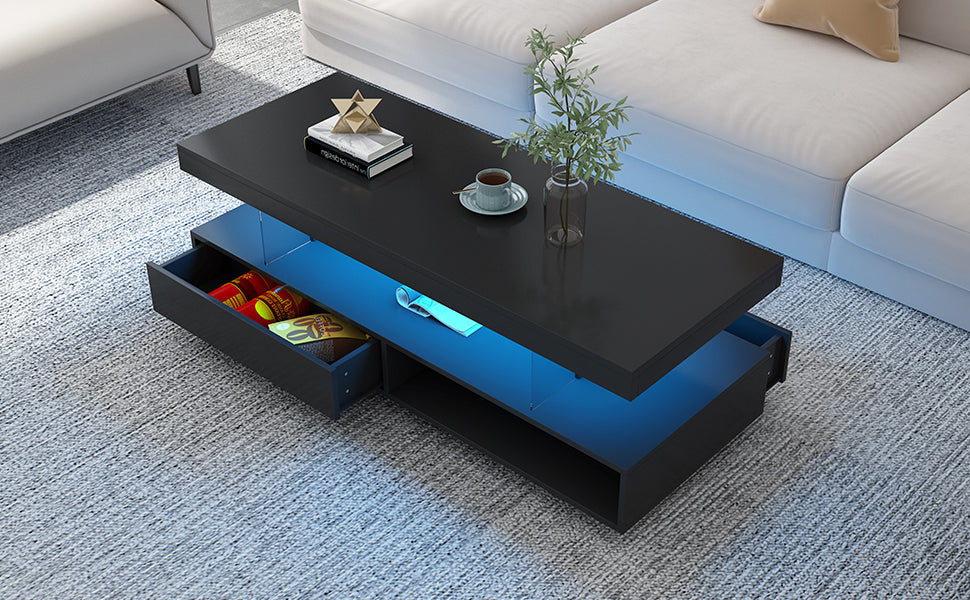 Black LED coffee table with blue-lit display shelf and one drawer open with packaged items