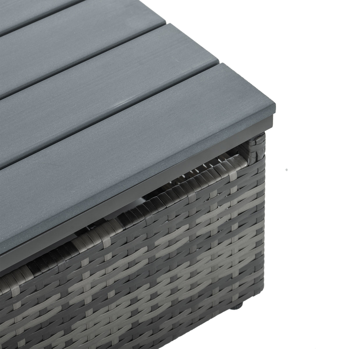 Corner view of dark gray cushion atop woven wicker frame