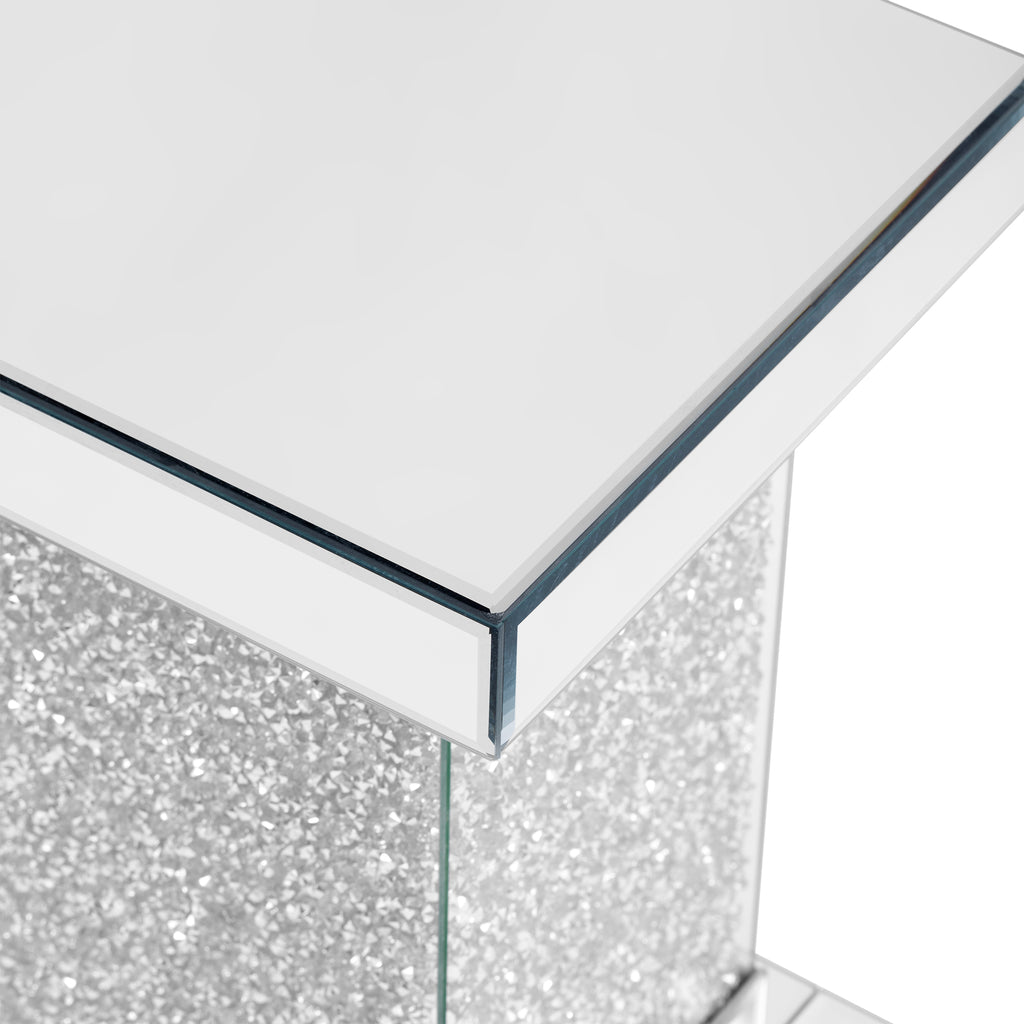 Close-up of the silver glass tabletop edge on a square mirror coffee table