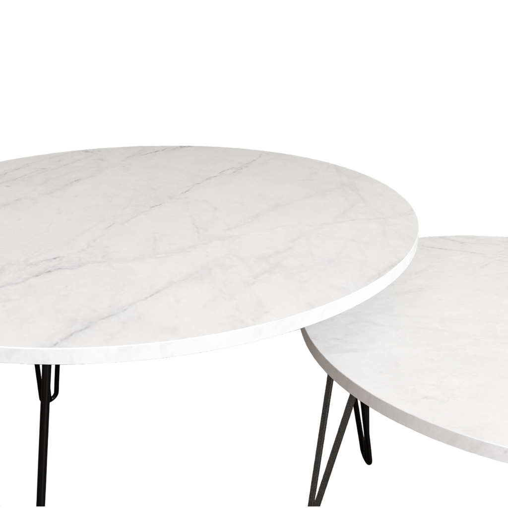 Close view of white marble-look round nesting table top with black metal legs