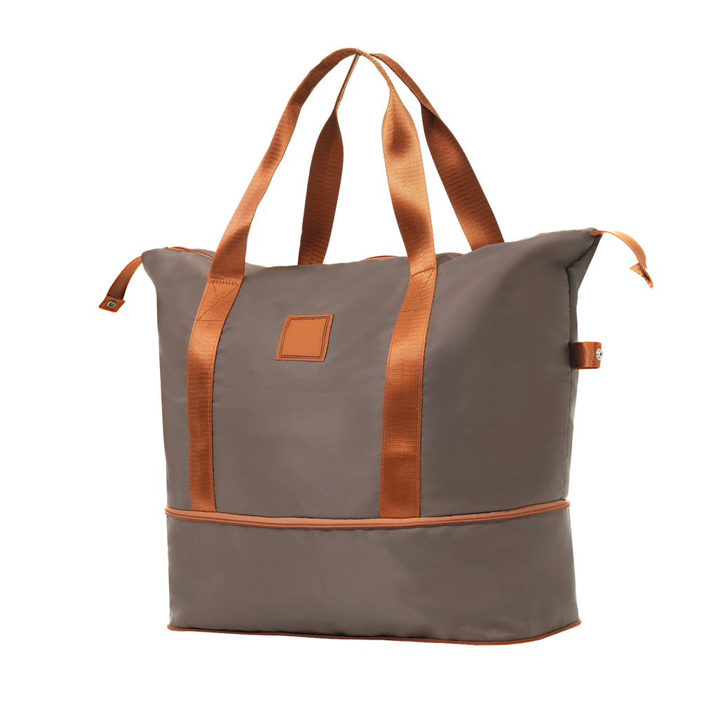 Gray travel duffle bag with copper webbing handles and front patch pocket