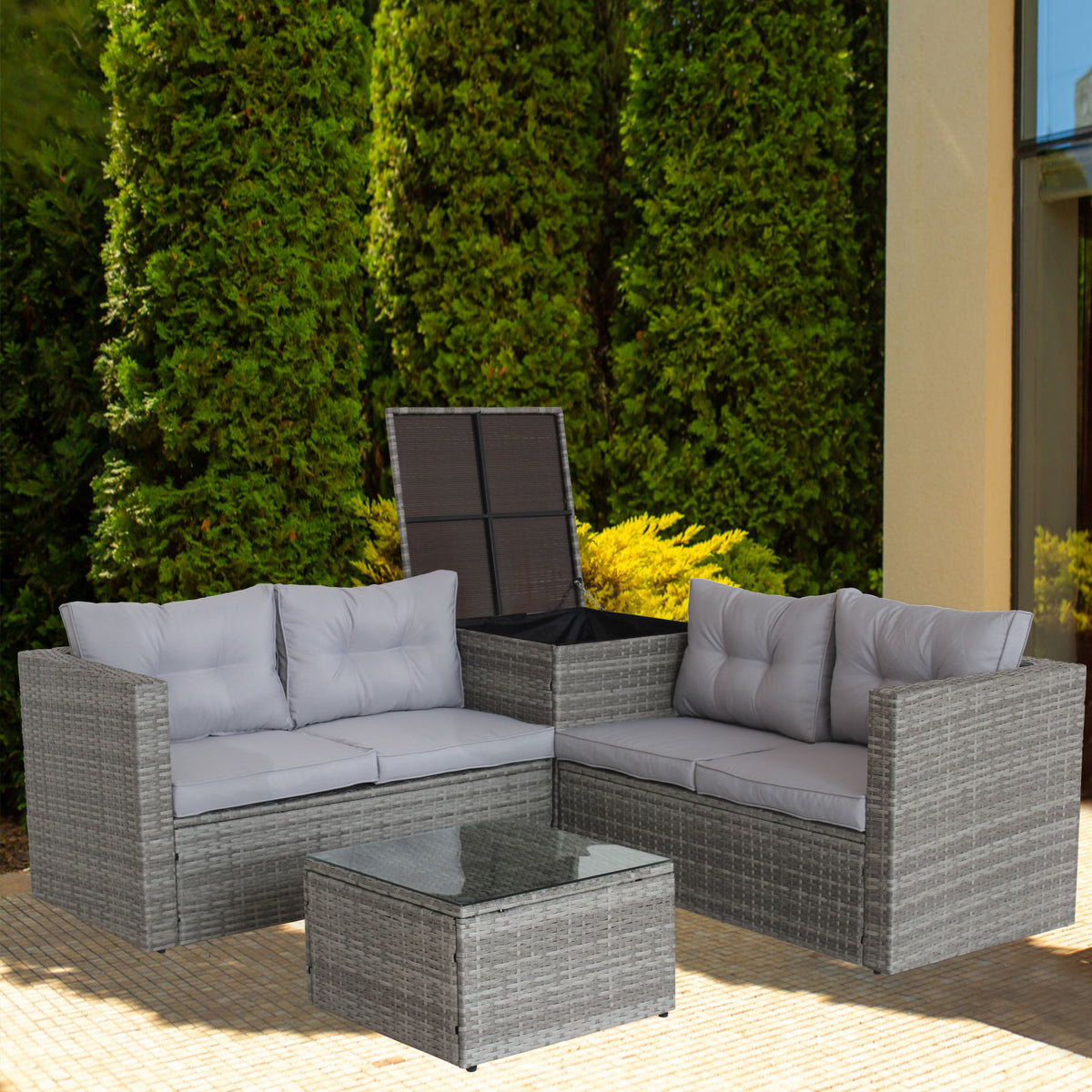 Grey wicker outdoor sectional with white seat cushions and glass top coffee table