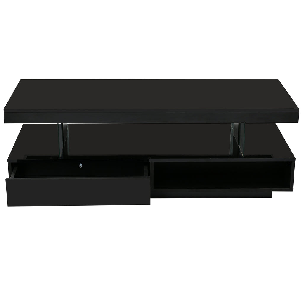 Black coffee table with two drawers pulled open to show interior storage compartments.