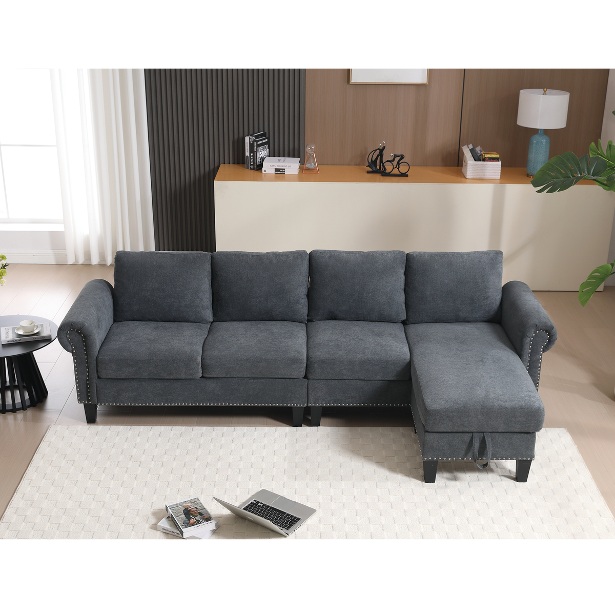 Gray sectional sofa with chaise, padded back cushions and nailhead-trimmed base
