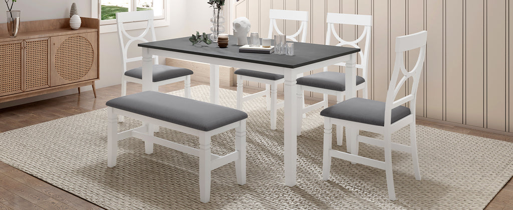 White farmhouse dining table set with gray upholstered bench and matching gray-cushioned chairs