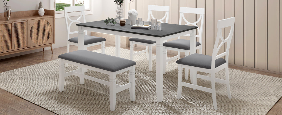 White farmhouse dining table set with gray upholstered bench and matching gray-cushioned chairs