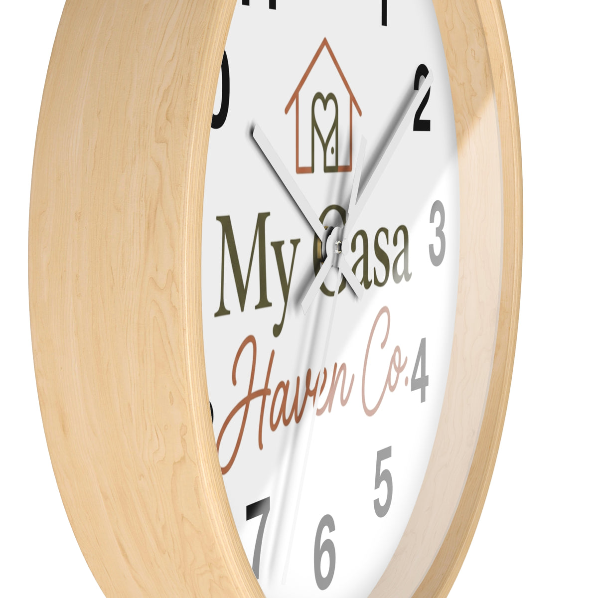 Wood wall clock with light wood frame, close angled view of numbered white face and white hands