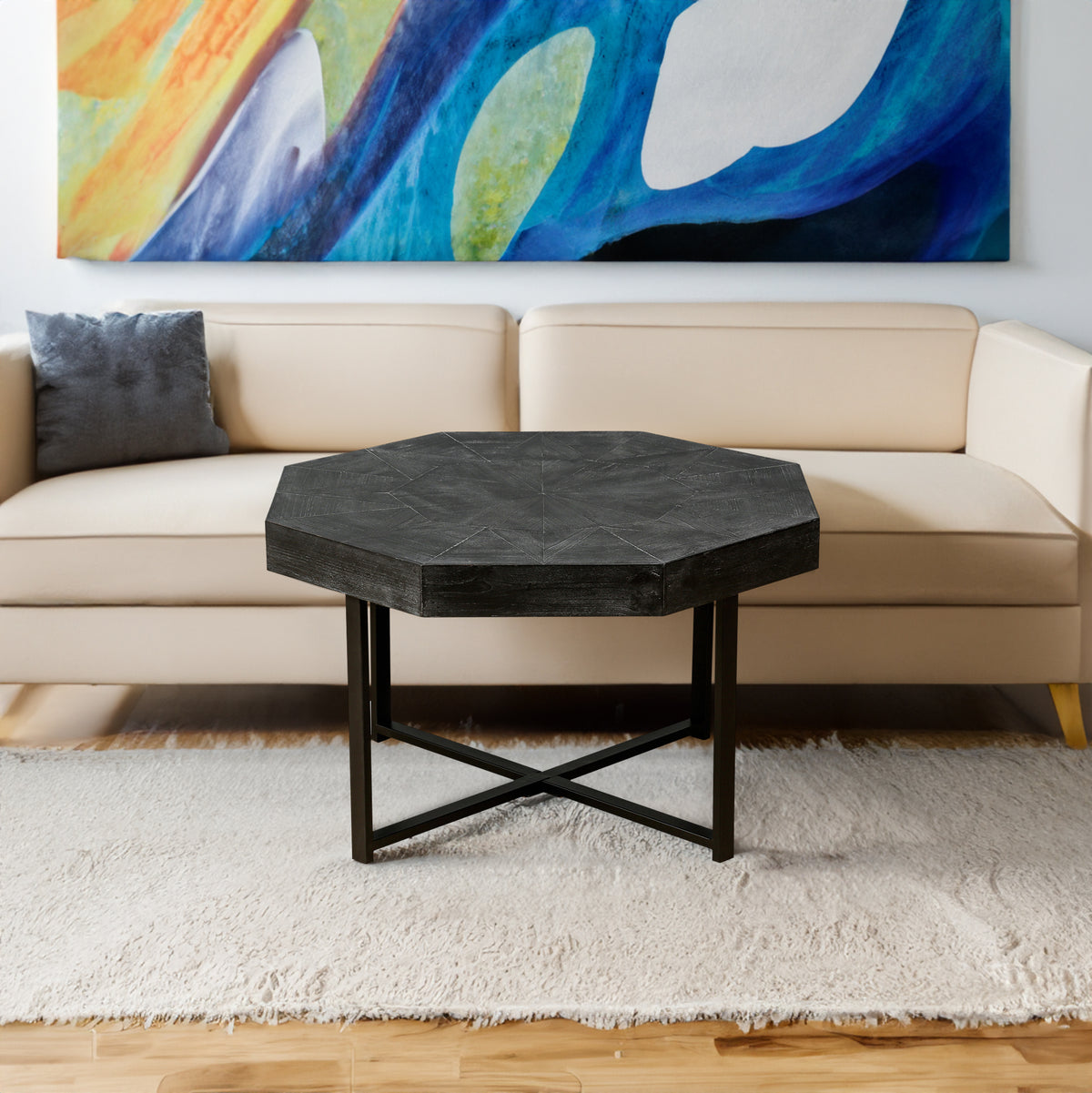 Antique black octagonal coffee table with metal X-frame legs and textured tabletop