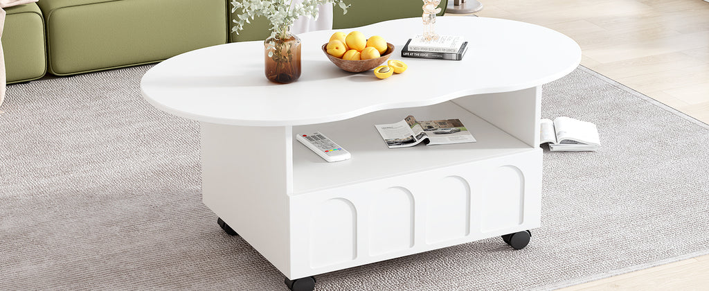 White round coffee table with open shelf and drawer, caster wheels; books and decor on top