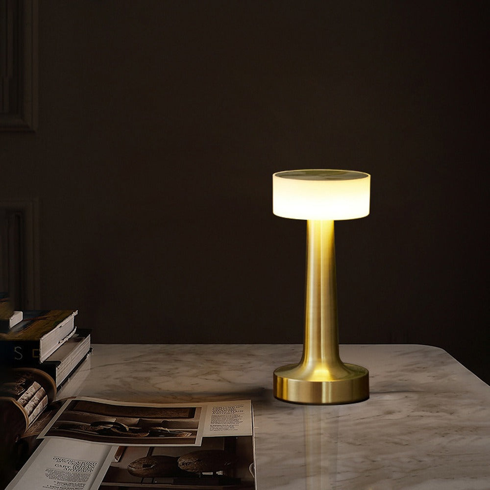 Gold retro table lamp with glowing LED light and drum fabric shade