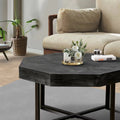 Antique black octagonal coffee table with metal X legs and textured surface