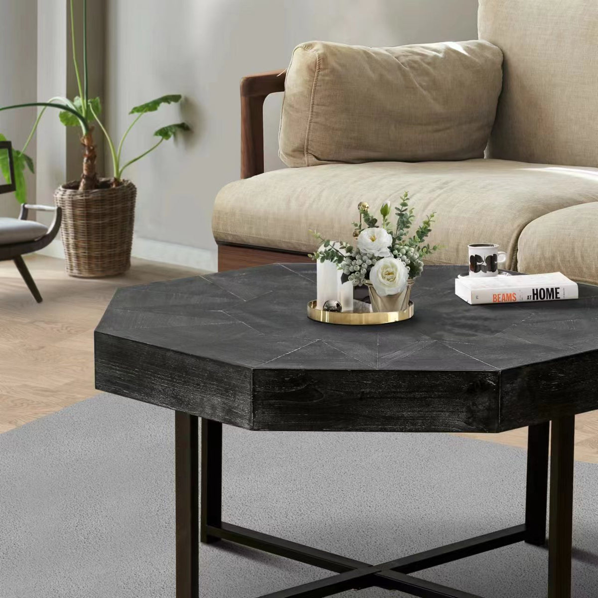 Antique black octagonal coffee table with metal X legs and textured surface