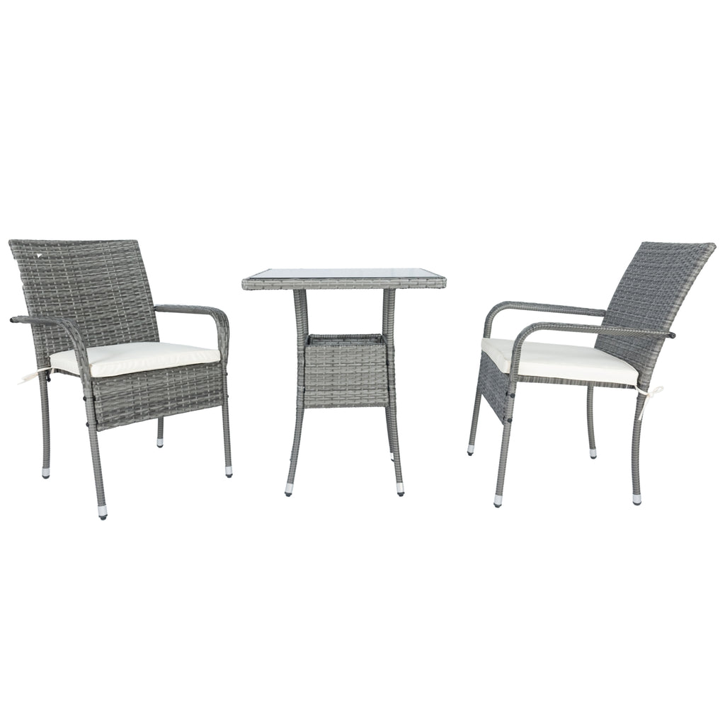 Grey wicker conversation set with two armchairs, white cushions, and central glass-top table
