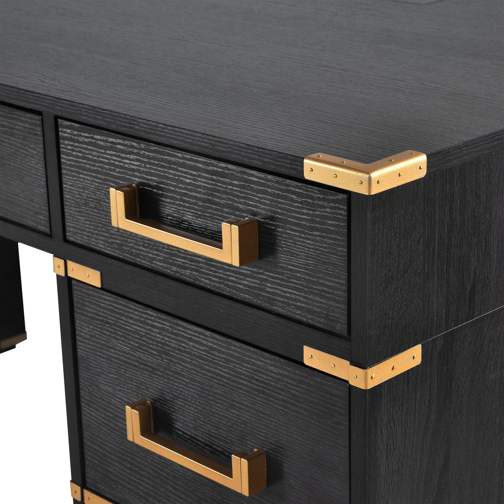 Black executive desk with gold metal edge trim, front file drawers, and pull handles.