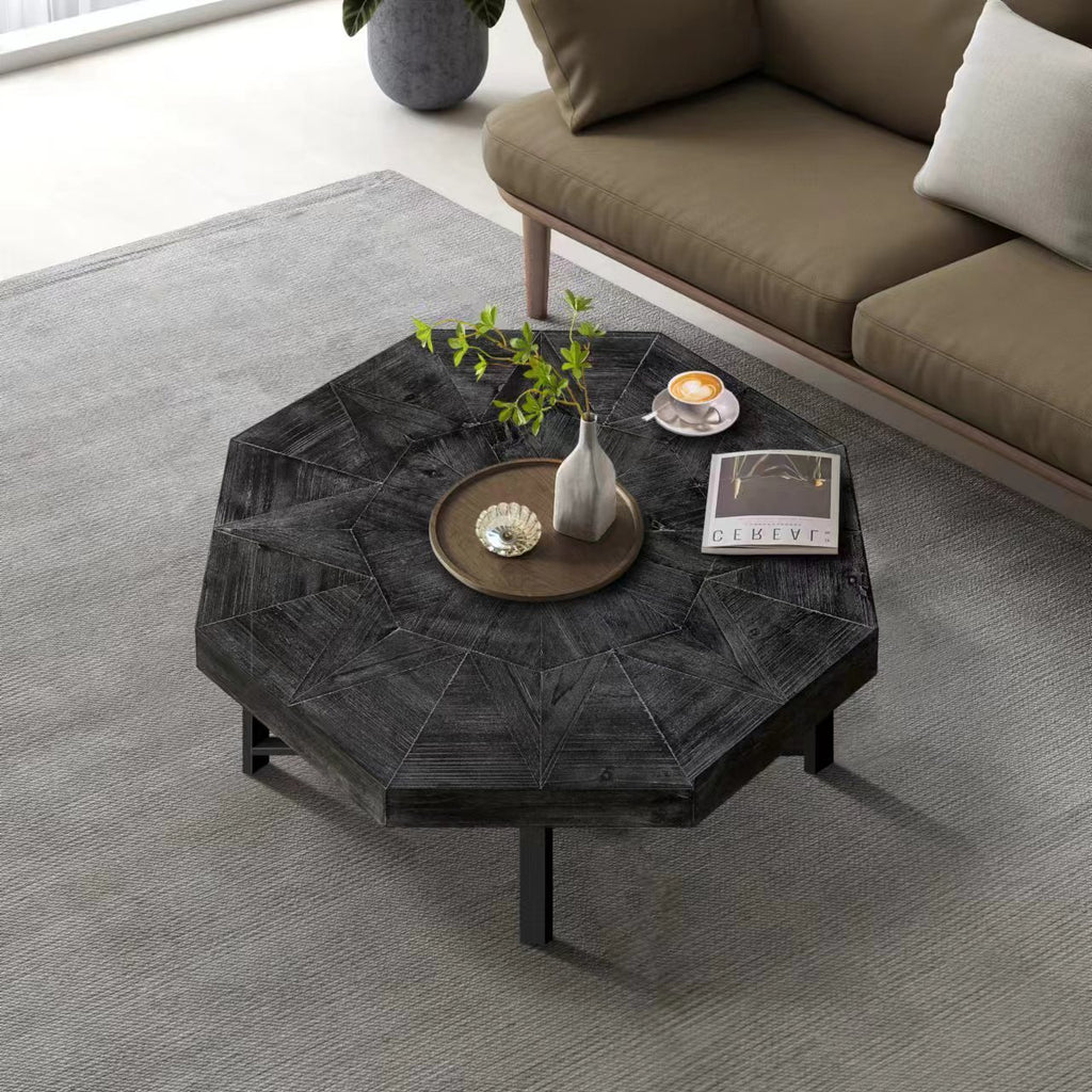 Antique black octagonal coffee table with textured top and metal cross legs