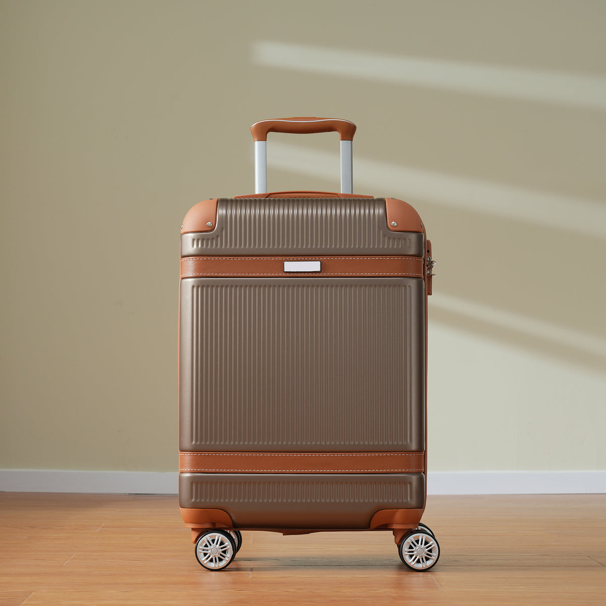 Coppery carry-on suitcase standing upright with top handle and four spinner wheels