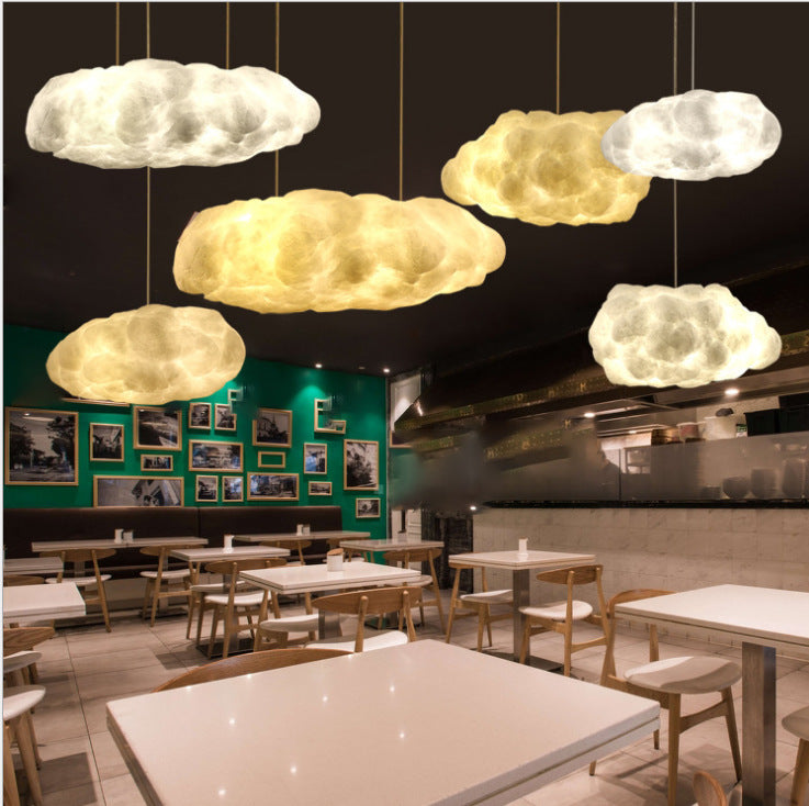 Cloud-shaped LED pendant lamp with warm glowing fabric shades on hanging cords