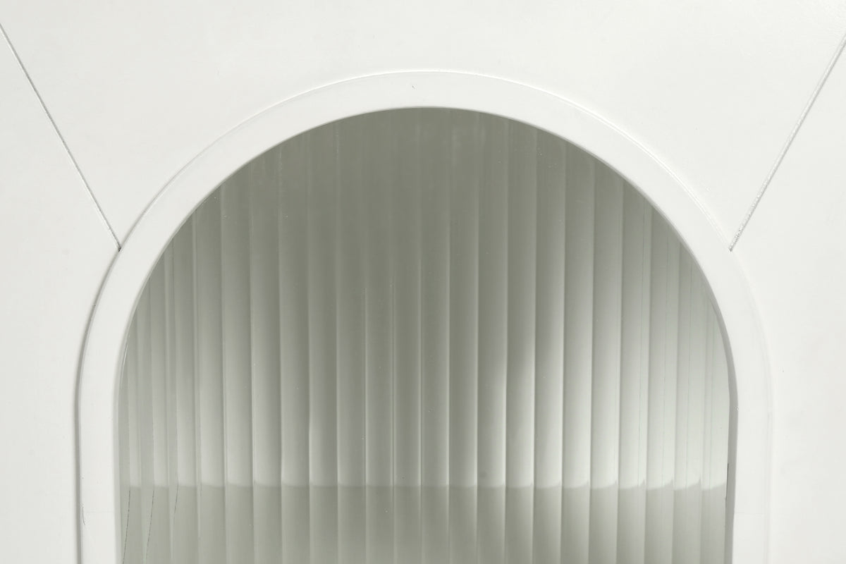 Close-up of antique white arched glass cabinet door with ribbed glass panel