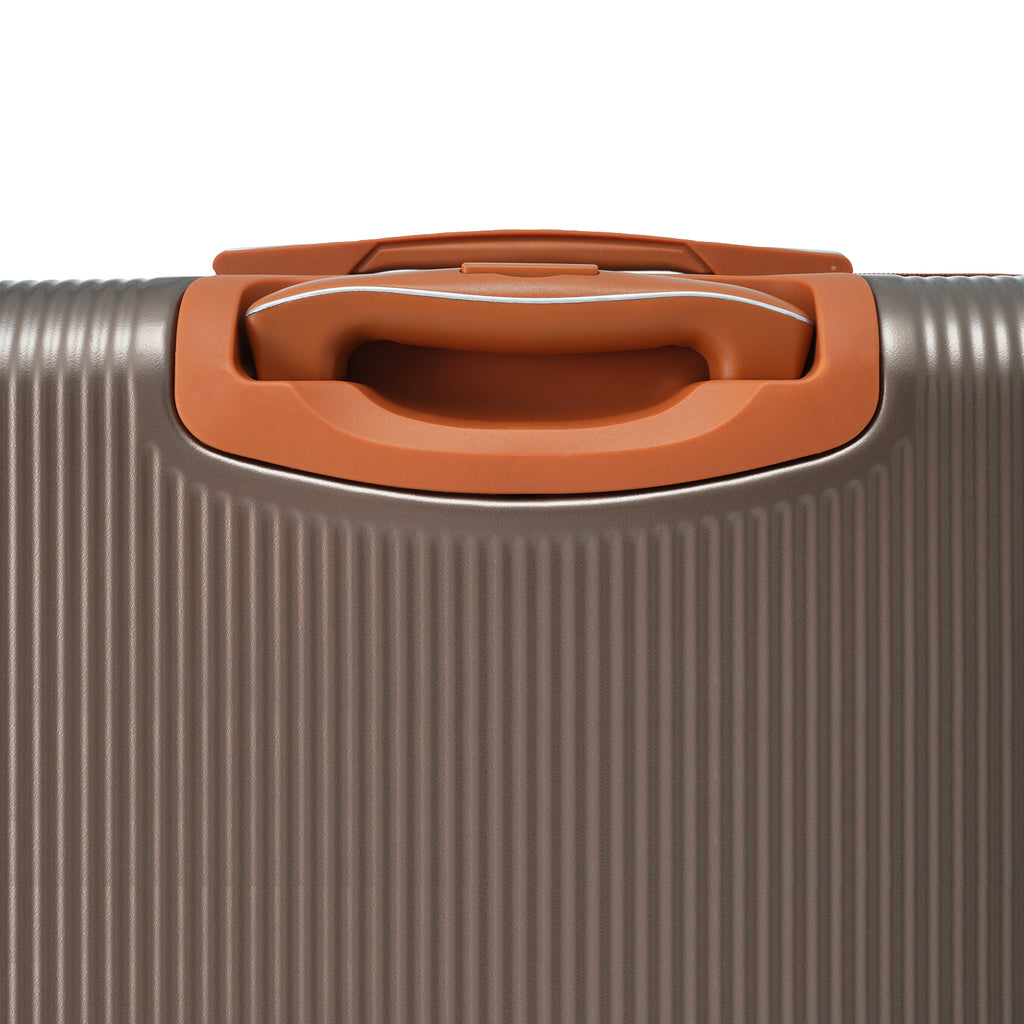 Coppery pull-up handle on hard-shell suitcase