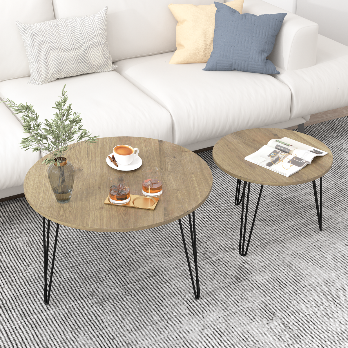 Round nesting coffee table set of 2 with light brown wood tops and black metal legs