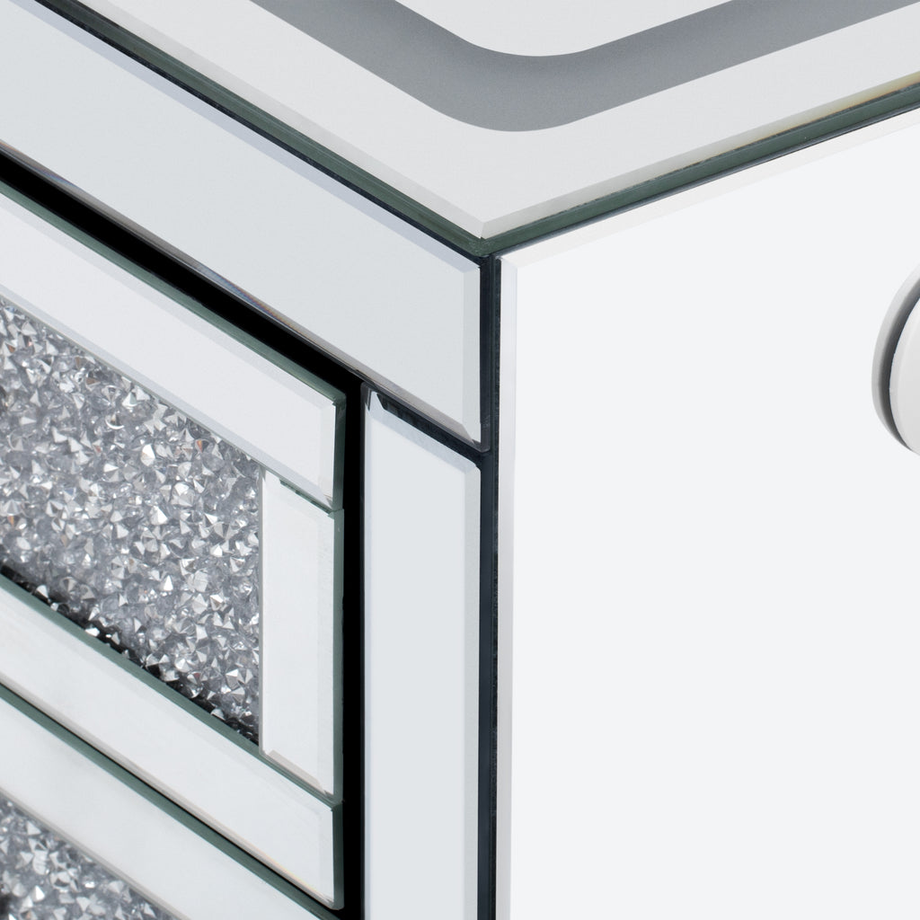 Close-up of mirror-style metal corner trim on silver coffee table edge