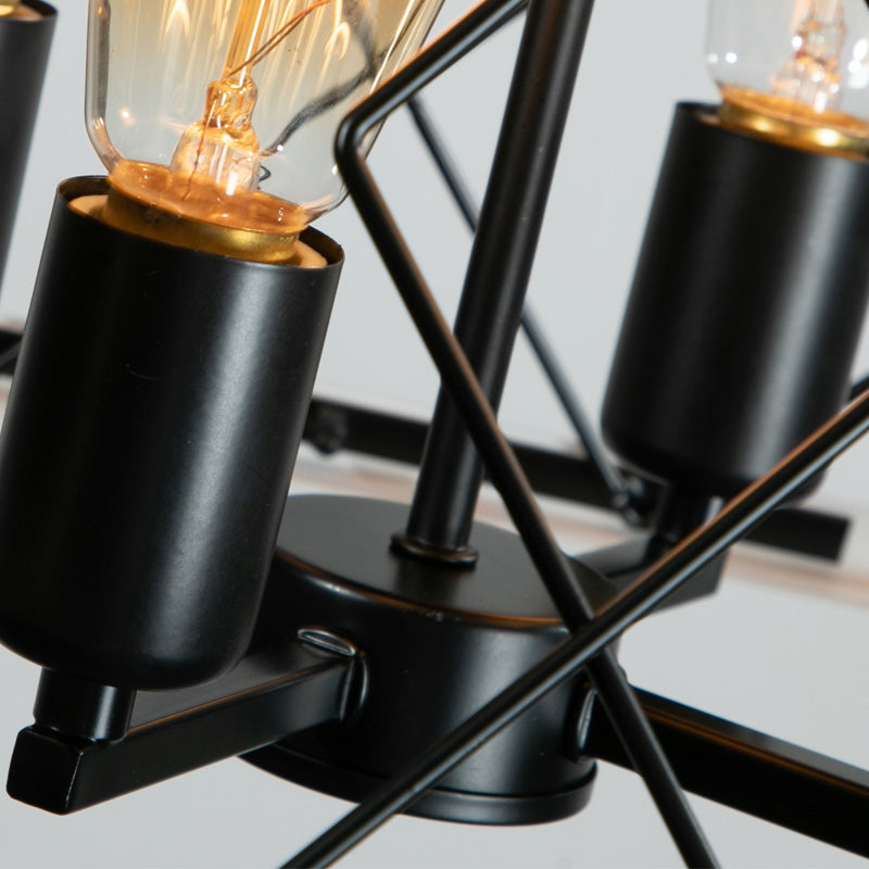 Close-up of black metal candle-style light fixture sockets inside the cage.