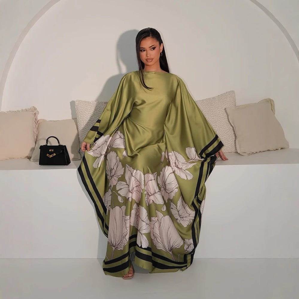 Green printed dress with white floral design and dark striped trim along hem and sleeves