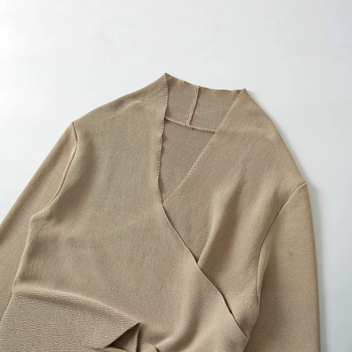 Khaki V-neck knit sweater detail with wrap overlap and ribbed collar