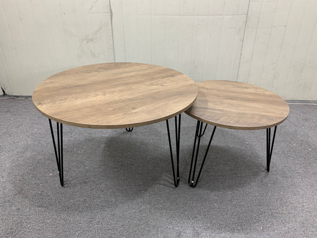 Set of 2 round nesting tables with distressed light-brown wood tops and black legs