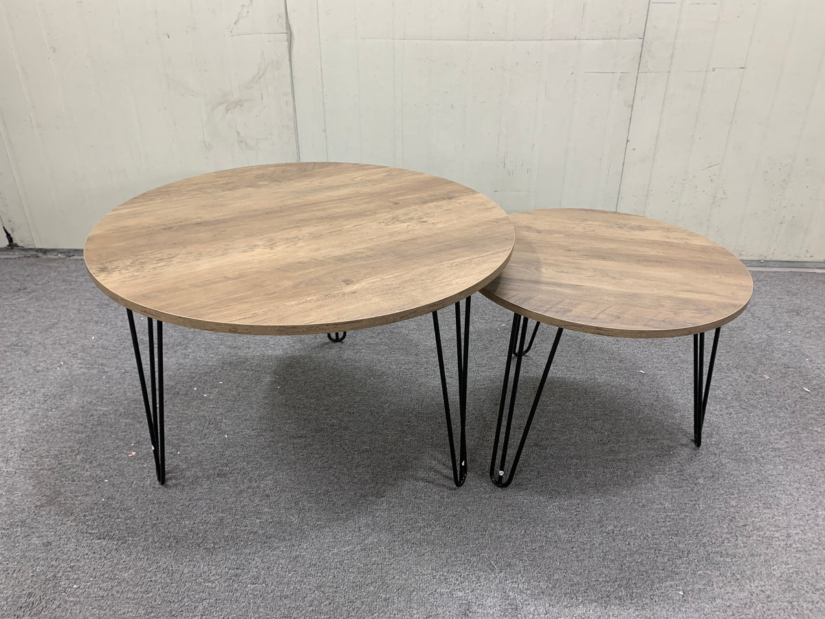 Set of 2 round nesting tables with distressed light-brown wood tops and black legs
