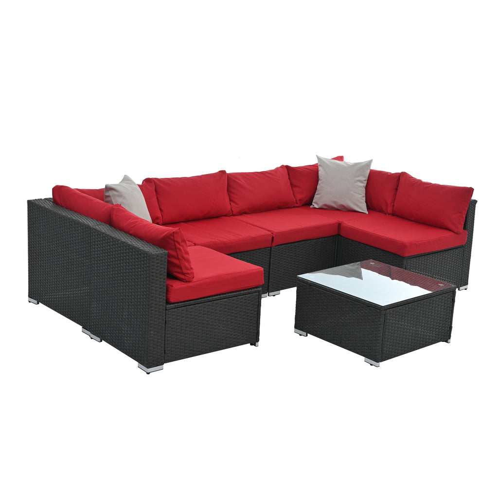 Dark gray woven outdoor corner sofa set with red cushions and square glass coffee table