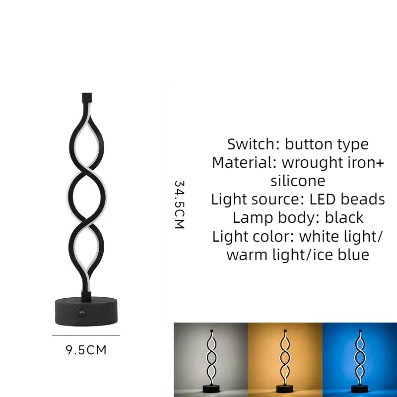 Black bar table lamp with looped frame and round base, warm white glow