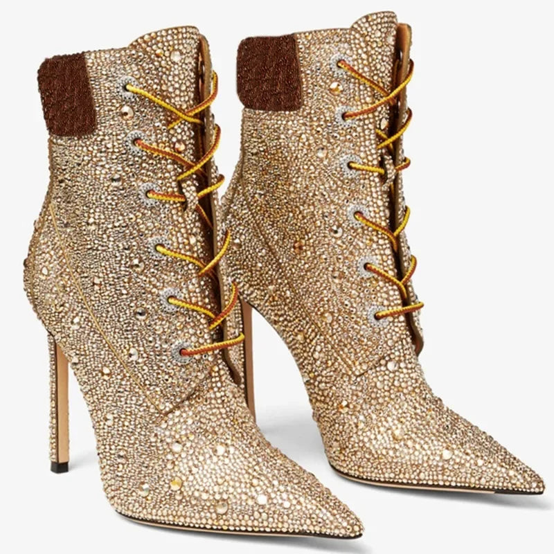 Pair of champagne rhinestone lace-up ankle boots with dark brown cuff and stiletto heel