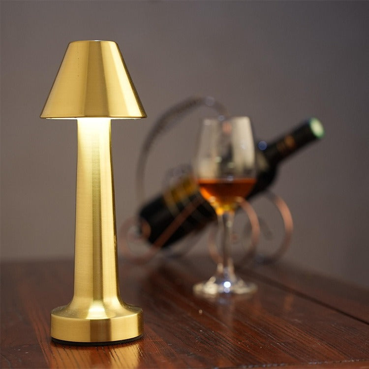 Gold retro table lamp with drum fabric shade and warm glowing LED base
