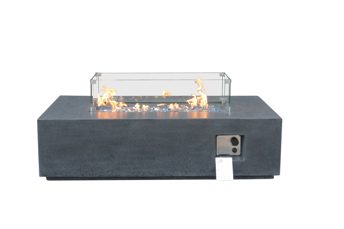 Dark gray propane fire pit table with glass wind guard and lit flames, side view