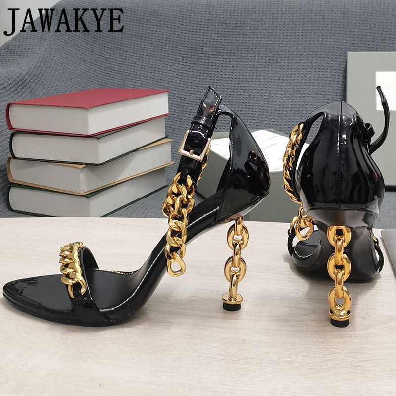 Black high-heel sandal with gold chain detail and ankle strap, glossy finish