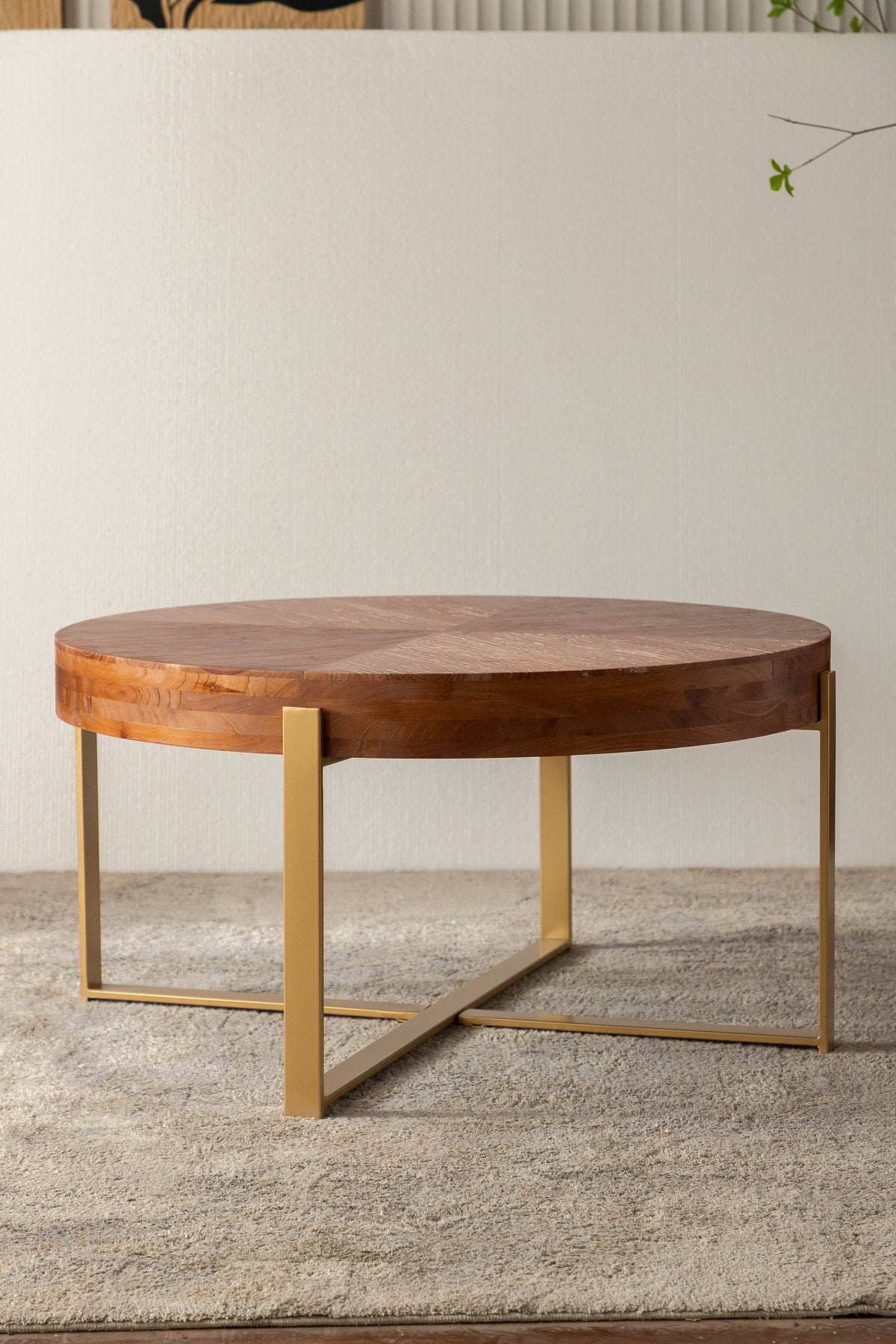 Round fir wood coffee table with gold metal legs and wide circular top