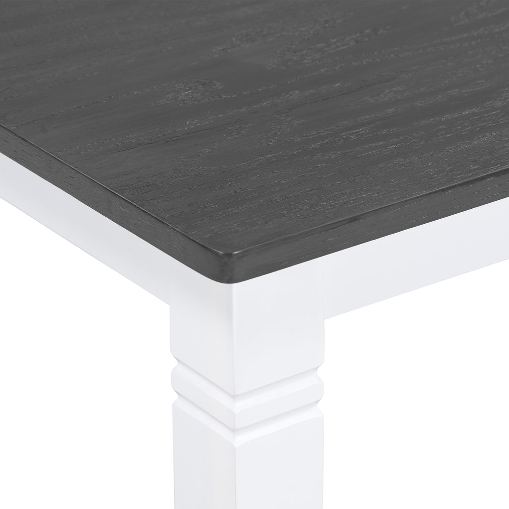Dining table corner with dark gray tabletop and white pedestal base