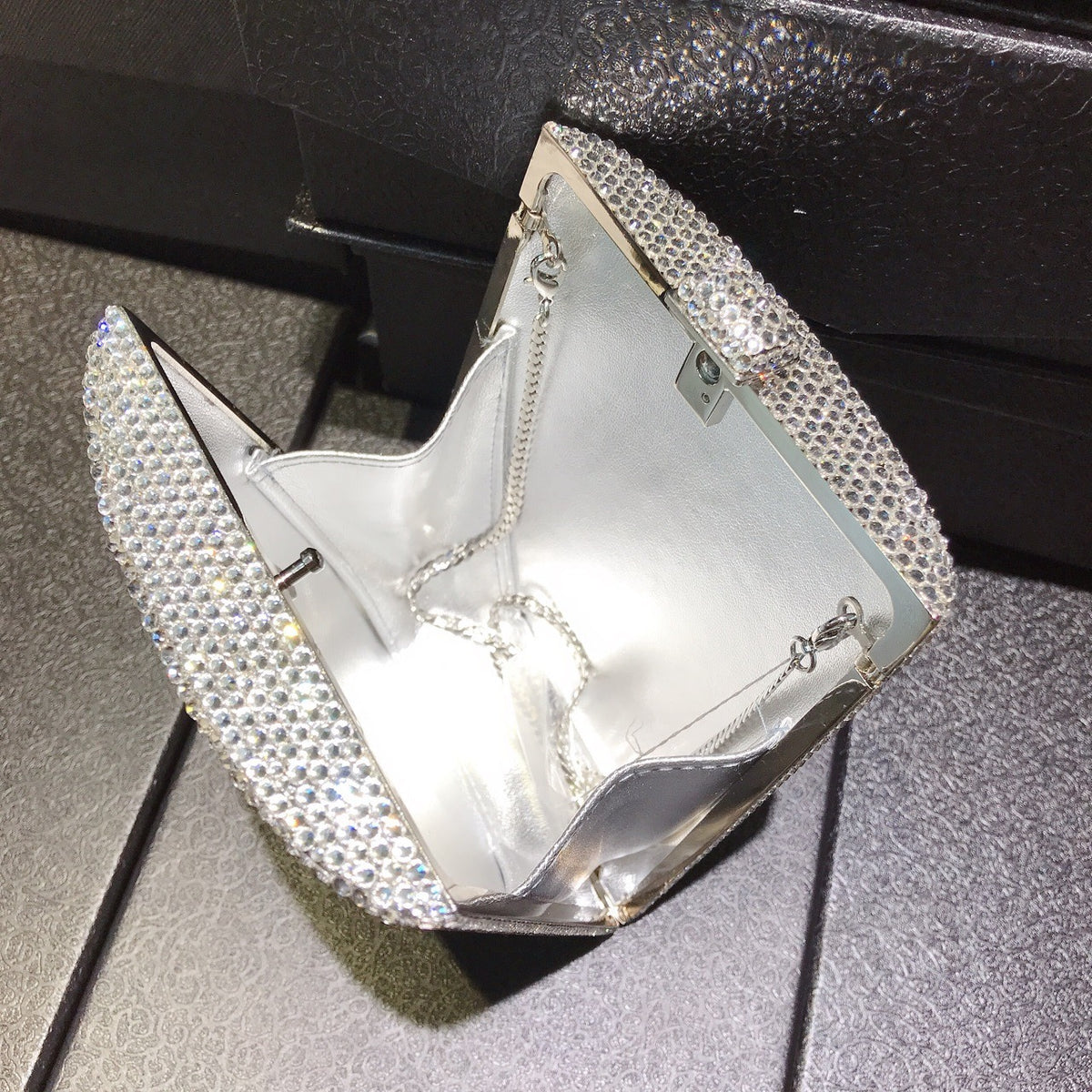 Silver rhinestone handbag with chain strap, open-top frame and letter panel