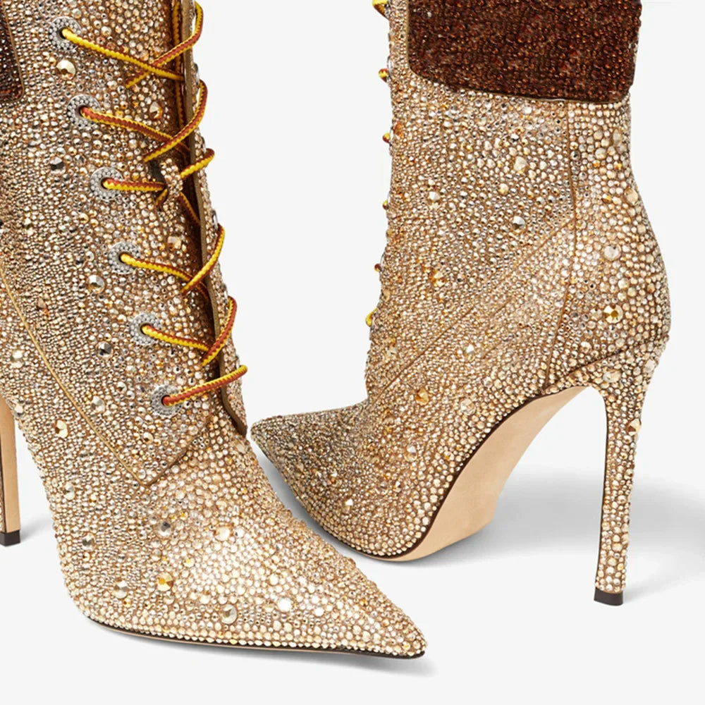 Front close-up of champagne rhinestone ankle boots with dark brown cuff and stiletto heel