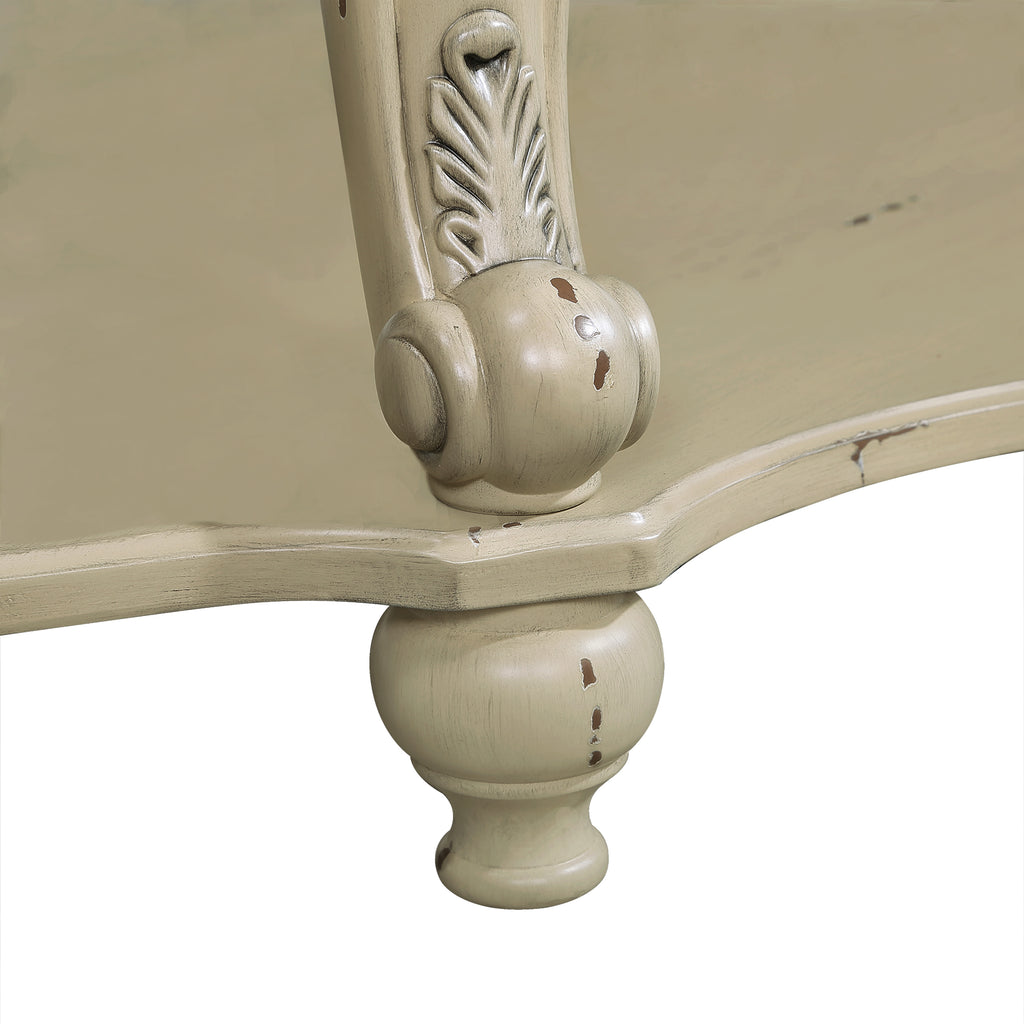 Antique white carved table leg with decorative floral motif and rounded foot