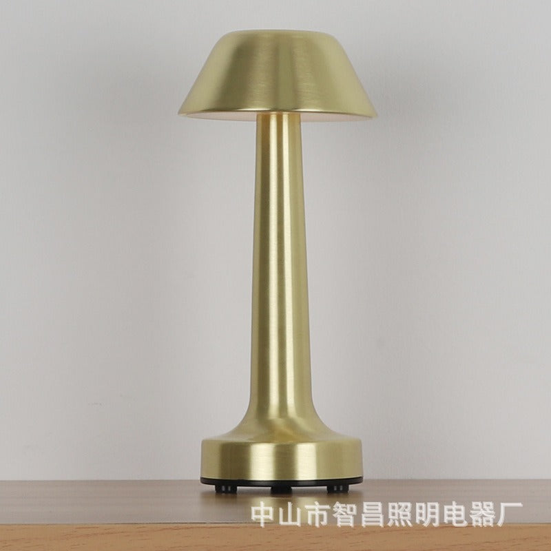 Gold retro table lamp with drum fabric shade and tall cylindrical metal body