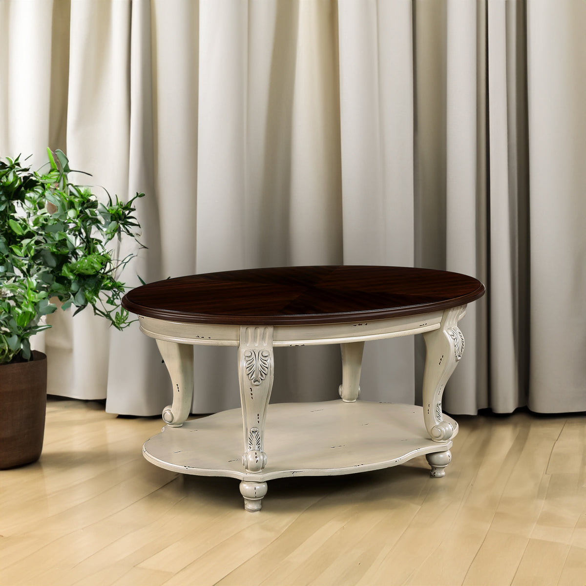 Antique white oval coffee table with dark cherry top and open lower shelf