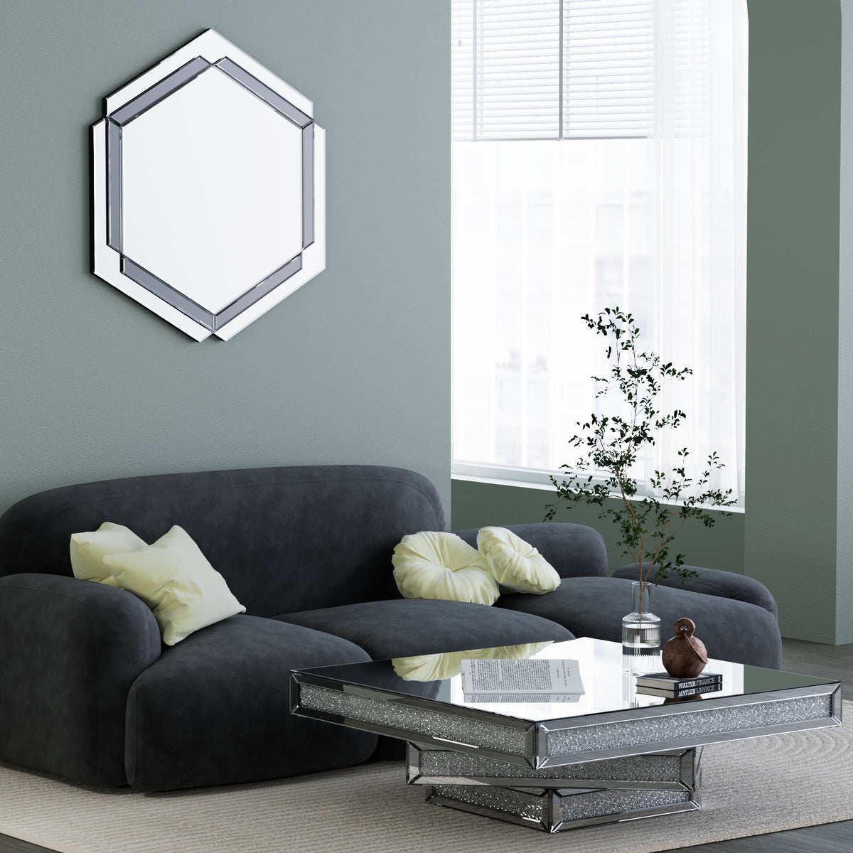Small wall-mounted silver octagon mirror above a dark sofa and glass coffee table