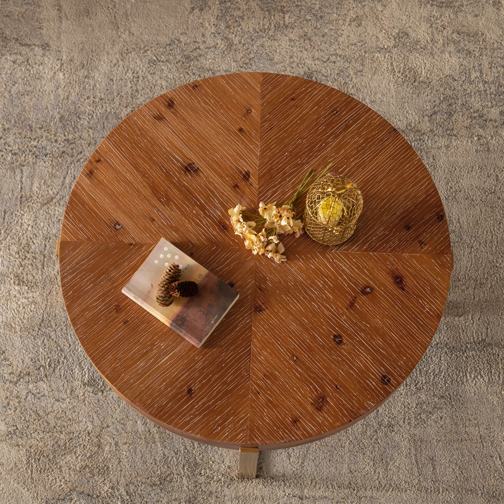 Round fir wood coffee table with circular tabletop and gold-toned base legs